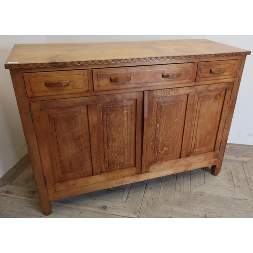 140 - Arts and crafts style oak sideboard with central drawer flanked by two short drawers above two panel... 