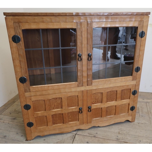 141 - Yorkshire oak craftsman made Mouseman style side cabinet with two lead glazed doors and two glass sh... 