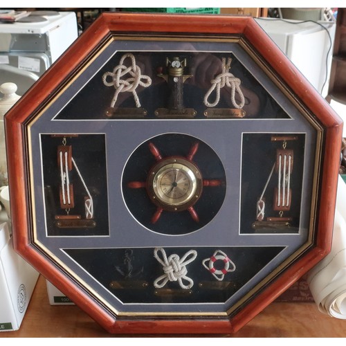 392 - Modern framed nautical display with central clock surrounded by various knots etc (43cm x 43cm)