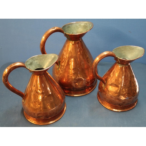 21 - Copper gallon rum flagon with loop handle and two similar half gallon flagons (3)