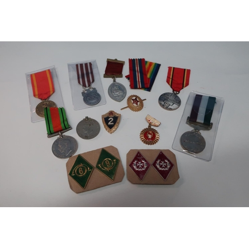 35 - Group of various medals and commemorative medals, cap badges etc including 39-45 War and Defence med... 