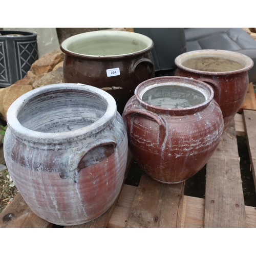 254 - Four terracotta painted pots