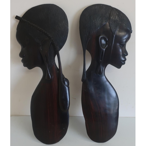 44 - Pair of Eastern carved hardwood wall plaques in the form of females (height 59cm) (2)