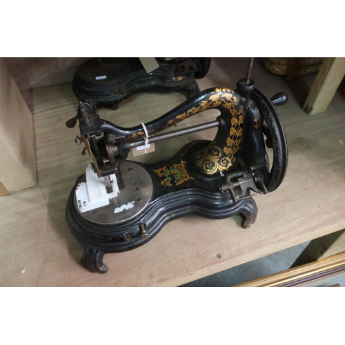 32 - Smith & Sons vintage sewing machine, on shaped base with scroll feet and gilt decoration (length 34c... 