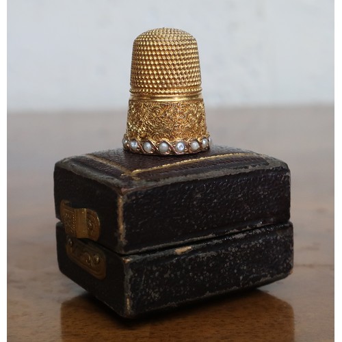 36 - Victorian gold plated thimble with seed pearl and scroll decoration, in fitted box
