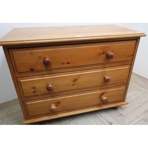 102 - The Cabinet Workshop Warwick, pine chest of three long drawers on bun feet (90cm x 72cm x 45cm)