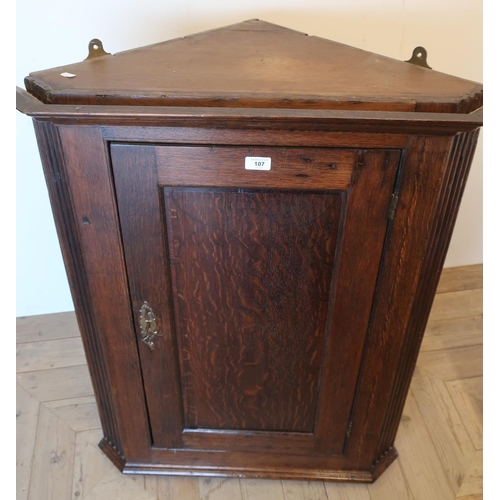 107 - George III oak corner cupboard, crossbanded door and painted two shelf interior with reeded corners ... 