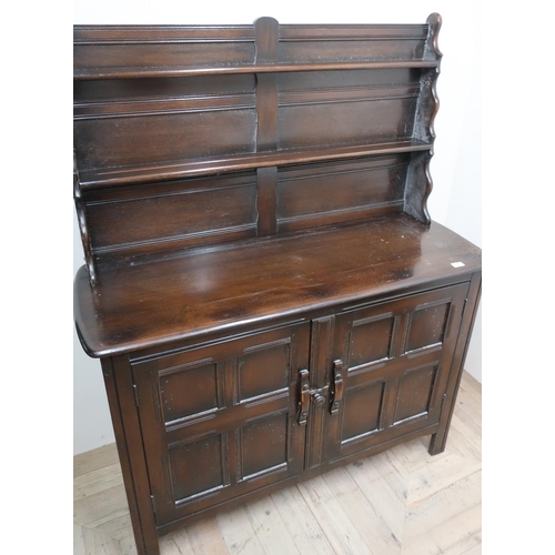 118 - Ercol dresser, twin shelf, low back, above two four paneled doors (122cm x 152cm x 46cm)