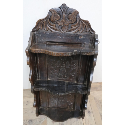 121 - Antique oak shelf, three shaped tiers with carved back  and cresting, bears date 1713 (54cm x 39cm)