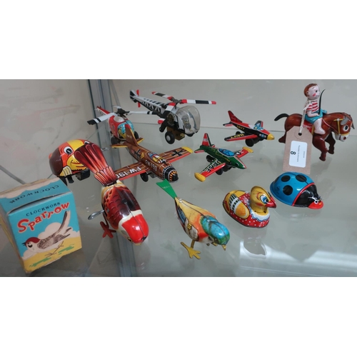 8 - Friction powered tin plate aeroplanes and helicopters, a boxed clockwork sparrow, donkey boy and oth... 