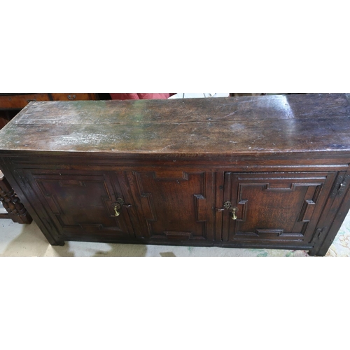 481 - George III oak backless dresser, twin planked top above a pair of geometrically molded doors, with c... 