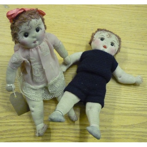 464 - Pair of fabric boy and girl dolls, blue suit and pink dress, both with painted detail and wool hair ... 