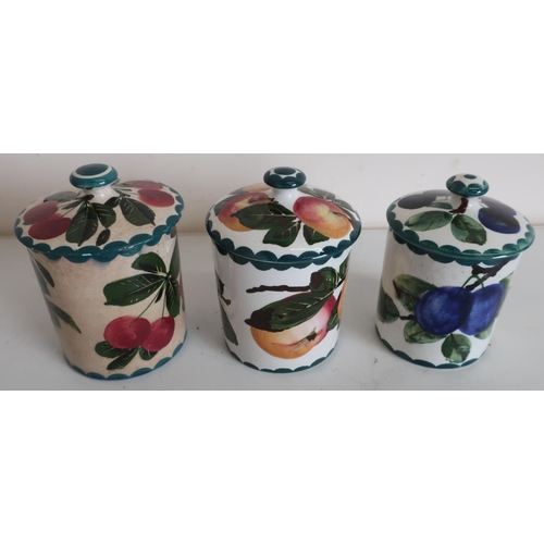44 - Three Wemyss Pottery preserve jars with lift off lids, decorated with plums and apples (approx heigh... 