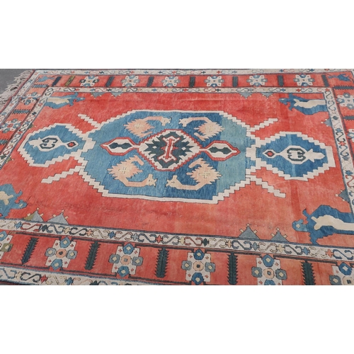 51 - Red and blue ground woollen rug (220cm x 325cm)