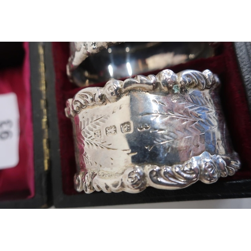 93 - Pair of Edwardian hallmarked silver oval napkin rings, with cast borders and engraved detail, Birmin... 