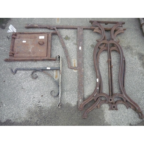 16 - Collection of cast metal leg ends, a oven crane , a small oven door, hanging basket bracket