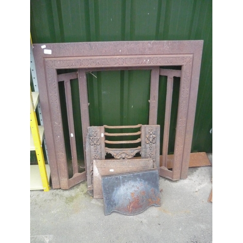 22 - Ornate cast iron fire surround with grate and iron fronts
