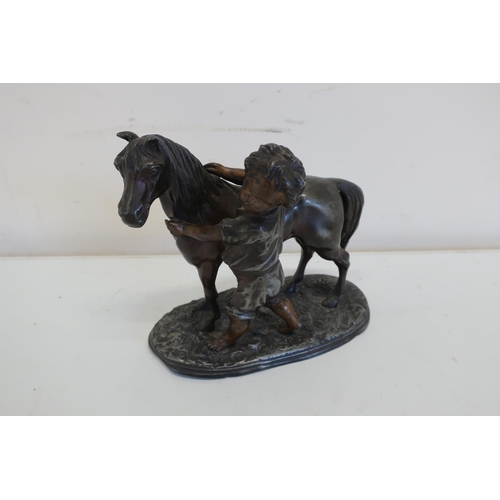 124 - Spelter figure of a boy and pony on oval base (14.5cm high)