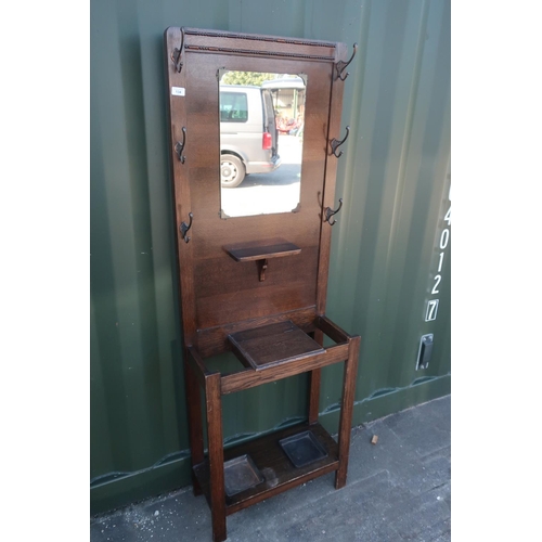 134 - 1930s oak hall stand with central mirror panel and lift up central compartment (61cm x 28cm x 175cm)