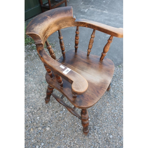 135 - Modern elm smokers bow elbow chair with double H shaped under-stretcher and turned supports