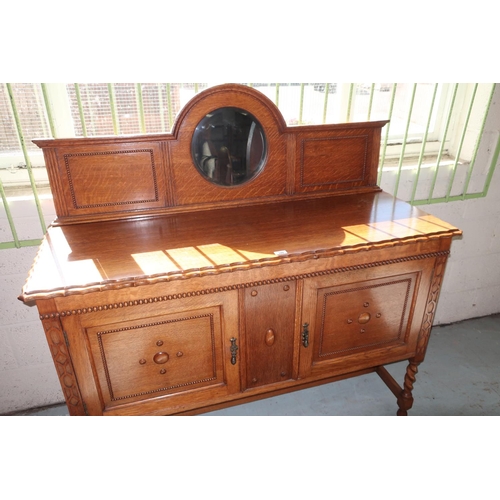 349 - 1930s oak sideboard, the raised arched back with circular bevelled mirror, pie crust carved top abov... 