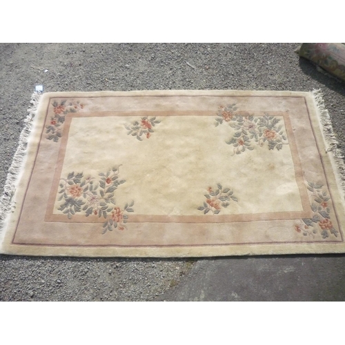 387 - Chinese embossed washed woollen rug, beige ground, decorated with flowers (263cm x 157cm)