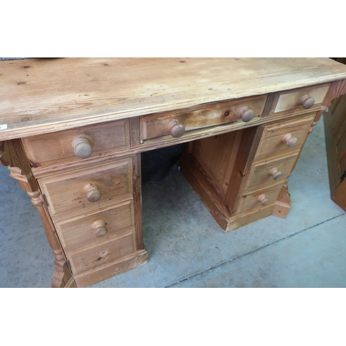 391 - Pine writing desk with rectangular top over nine drawers with turned wooden handles (122cm x 80cm x ... 