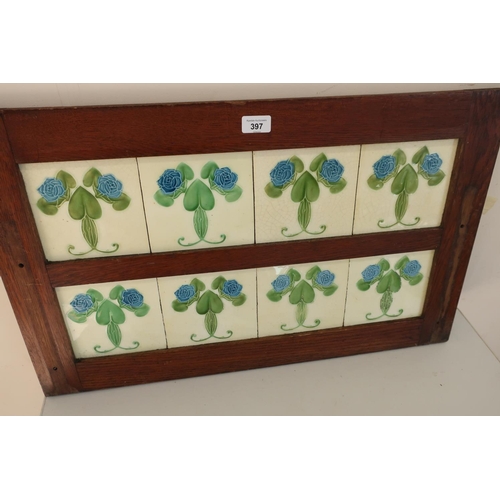 397 - Edwardian oak washstand splash-back inset with eight Art Nouveau tiles decorated with blue flowers a... 