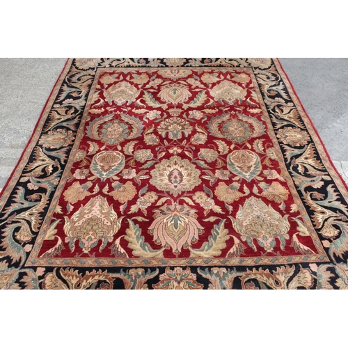 402 - 20th C traditional wool rug with central floral pattern field and stylised floral boarder (330cm x 2... 