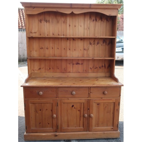 392 - Pine farmhouse dresser, twin shelf back above three drawers and three cupboard doors, on plinth base... 