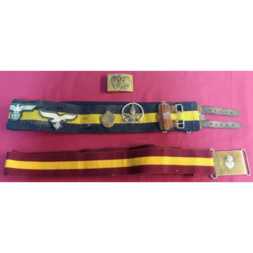 3 - Two stable belts, one with brass buckle, a Russian brass belt buckle and various badges mounted to t... 
