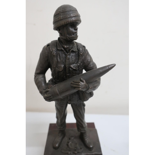 56 - Resin model of a Royal Artillery soldier, posed holding as shell on plinth (18cm high), and a money ... 