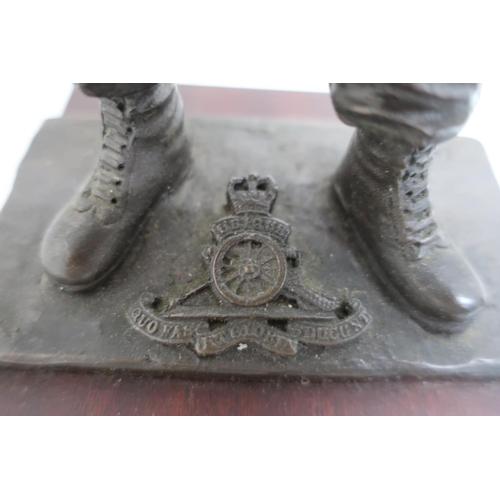 56 - Resin model of a Royal Artillery soldier, posed holding as shell on plinth (18cm high), and a money ... 