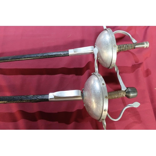 25 - Pair of reenactors style Rapier swords with cut basket hilts and scabbards, the tri-form blades mark... 