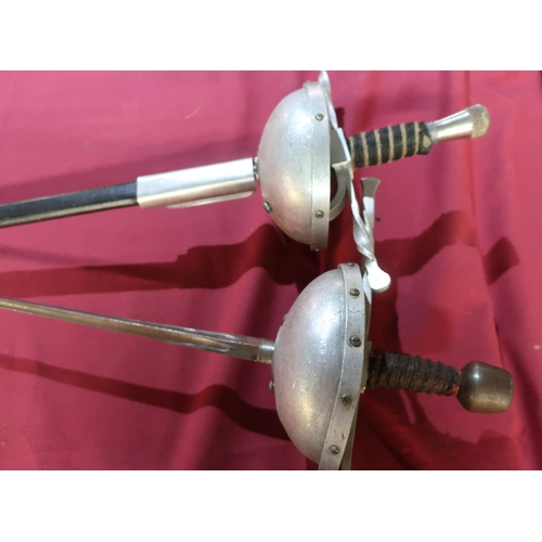 26 - Pair of reenactors style Rapier swords with cut basket hilts and scabbards, the tri-form blades mark... 
