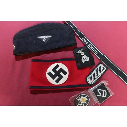 39 - Large collection of reproduction German WW2 badges, arm bands, side caps , belts , medals etc