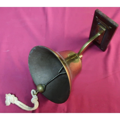 84 - Modern brass hanging ships type bell with clanger, mounted on to rectangular wooden wall plaque, wit... 