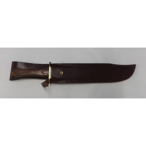 141 - Bowie type knife with 9 inch blade with brass cross piece and two piece wooden grip, made in Sheffie... 