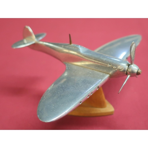 108 - Aluminium scale model of a Spitfire mounted on wooden stand (approx height 9cm)