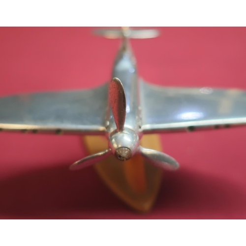 108 - Aluminium scale model of a Spitfire mounted on wooden stand (approx height 9cm)