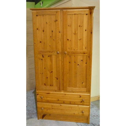 41 - Polished pine wardrobe enclosed by two panelled doors, with two drawers to the base (186cm x 94.5cm ... 