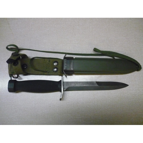 119 - Military style combat knife with 6 1/2 inch blade with double edged point, checkered composite grip,... 
