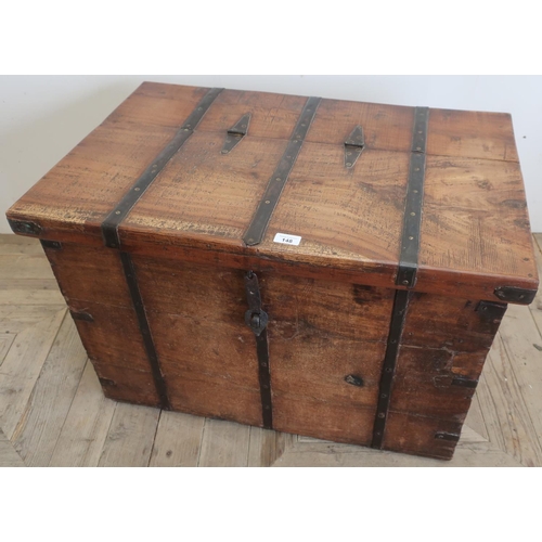 148 - Indian metal bound hard wood trunk, with hinged lid and strap catch (80cm x 51cm x 52cm)