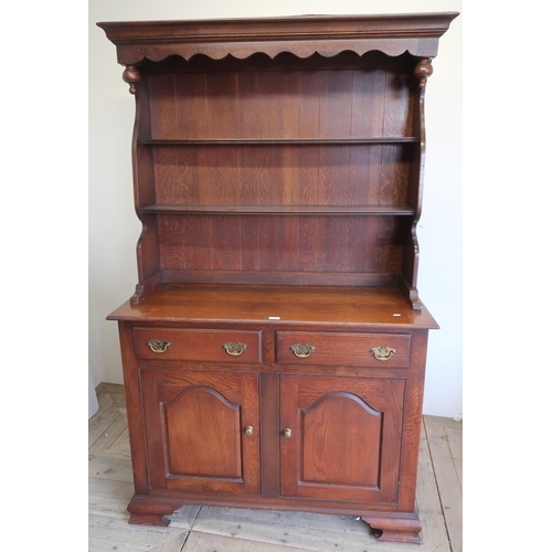 296 - George III oak style dresser, twin shelf back with shaped frieze above two drawers with arched panel... 