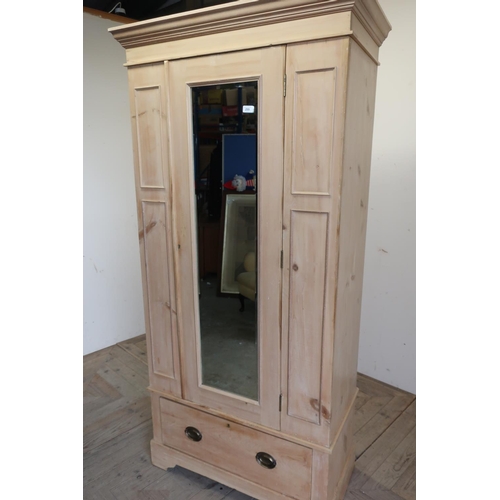 255 - Late Victorian stripped pine single mirrored door wardrobe, with single drawer to the base and panel... 