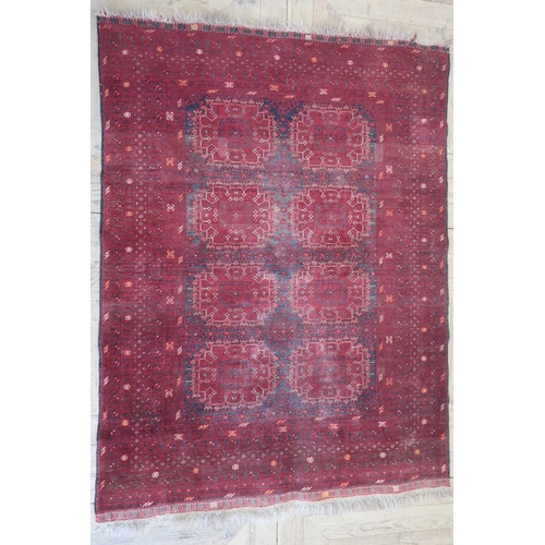 100B - Bokhara red ground rug, the field filled with repeating geometric motifs within a similar multi stri... 