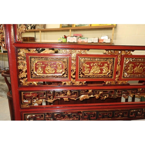 90 - Chiang Su red lacquered elm canopy bed, pierced headboard with gilt carved panels, the base with six... 