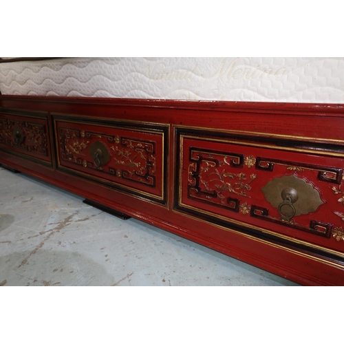 90 - Chiang Su red lacquered elm canopy bed, pierced headboard with gilt carved panels, the base with six... 