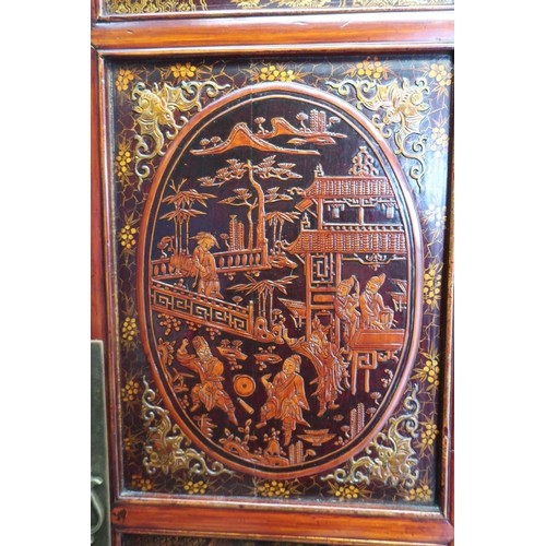 91 - Xi'An style lacquer wardrobe, the four panelled doors decorated with figures in pagodas and prunus b... 