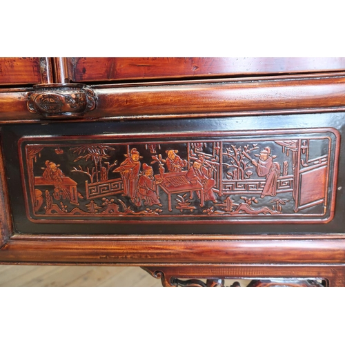 91 - Xi'An style lacquer wardrobe, the four panelled doors decorated with figures in pagodas and prunus b... 